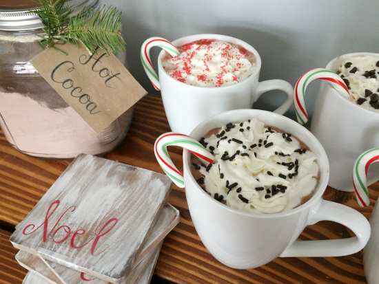 Several mugs of hot cocoa displayed with DIY wood coasters