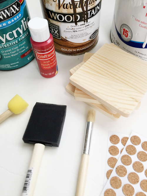 Items needed to make rustic DIY wood coasters: wood coasters, wood stain, paint, and paintbrushes