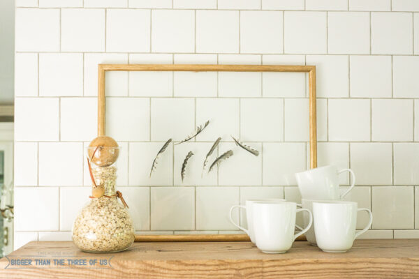 Framed feathers become free wall decor via Bigger Than the Three of Us