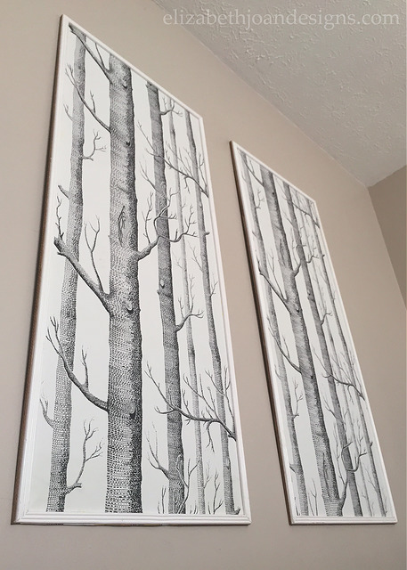 Large pieces of leftover wallpaper are framed for free wall decor via Elizabeth Joan Designs