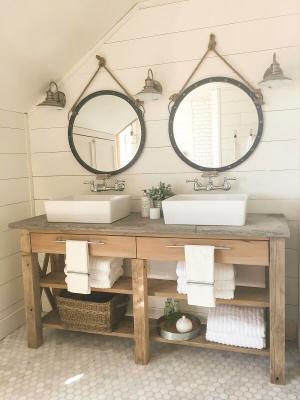 Farmhouse style bathroom with shiplap walls, large round mirrors, and double sinks