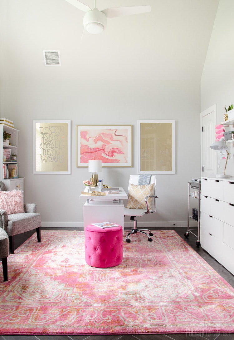 Office space with gray walls and pink accents throughout