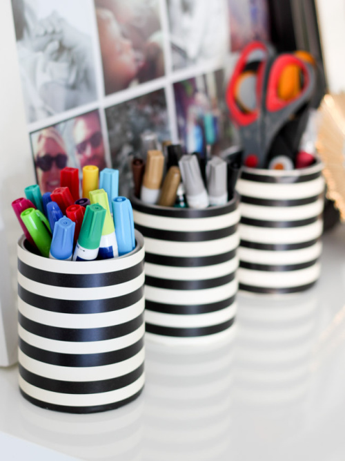 Tin cans wrapped in paper used to organize markers