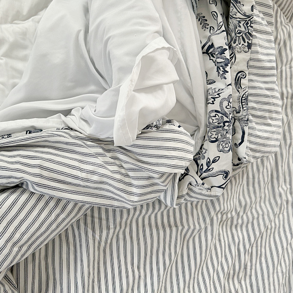 Heap of bedding on bed