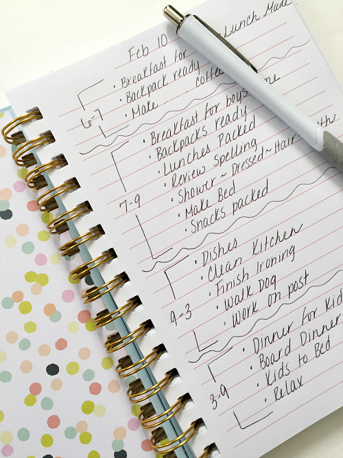 Notebook with daily times slots filled in with things that need to be done