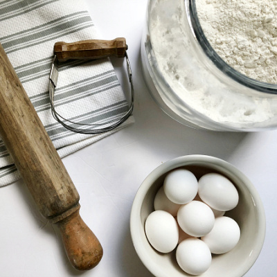Baking ingredients alongside a rolling pin and biscuit cutter