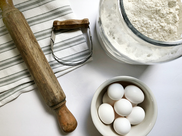 Baking ingredients: eggs, flour, rolling pin and biscuit cutter