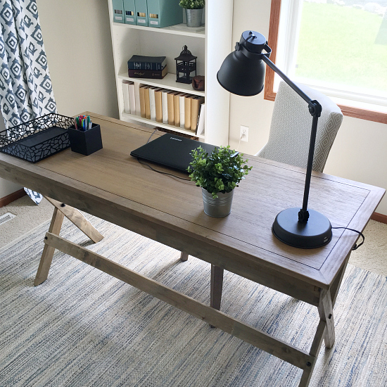 Desk area of this farmhouse office makeover featuring an industrial style lamp