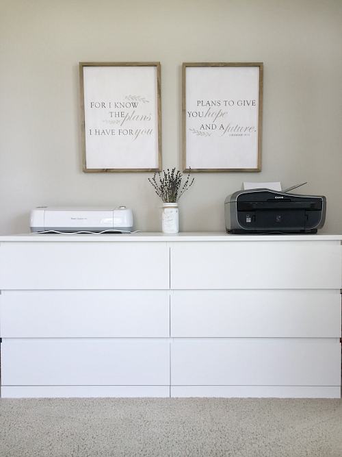 A dresser serves as storage for office supplies with a printer and Cricut on top