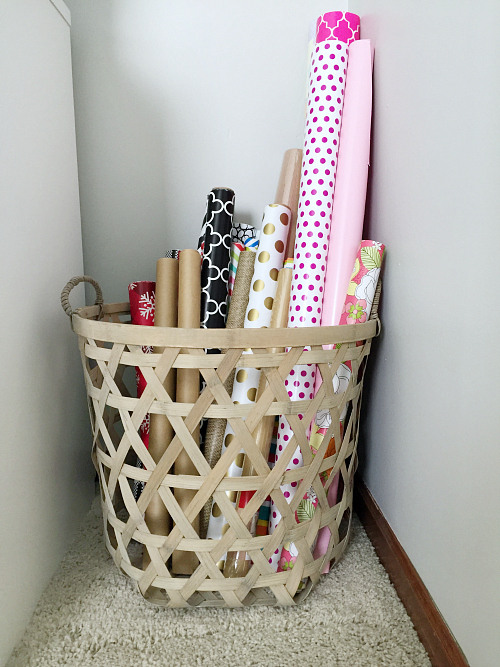 Basket holding rolls of wrapping paper