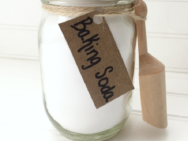 Baking soda in mason jar with small wooden scoop