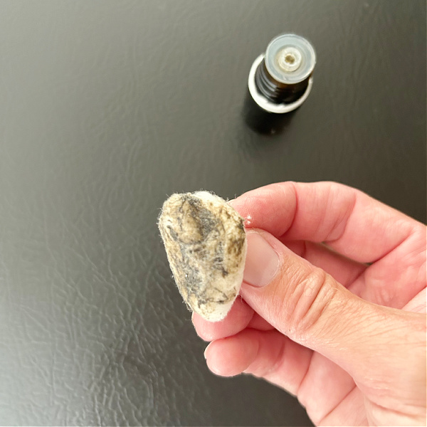 Cotton ball full of grease from top of refrigerator