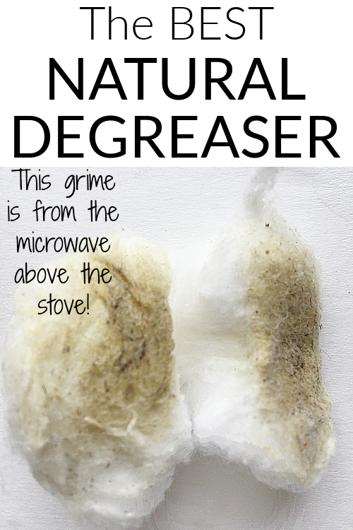 Two dirty cotton balls filled with grime from degreasing the microwave above a stove