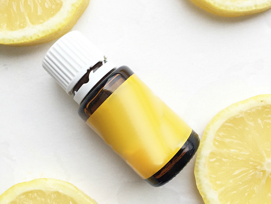 Lemon essential oil in the middle of lemon slices