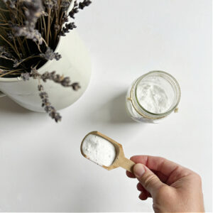 Scoop of baking soda in small wooden scoop