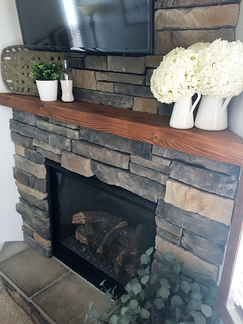 View of fireplace in a living room makeover for the $100 Room Challenge