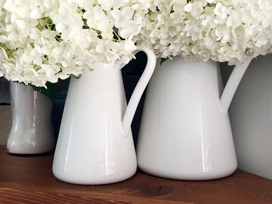 Living room makeover for the $100 Room Challenge: Pitchers filled with hydrangeas