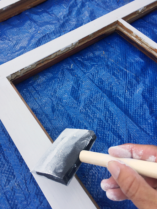 Applying white chalk paint to window frame