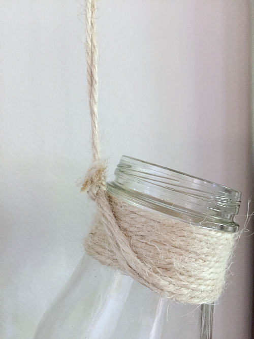 Close up of milk bottle tied with twine