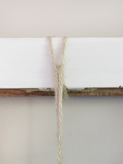 Close up of twine looped around top of window frame