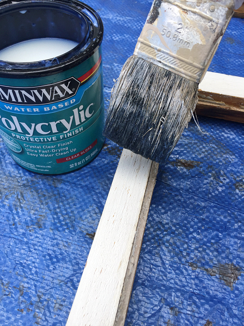 Applying polycrylic to window frame.