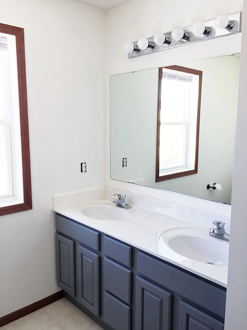 Builder grade bathroom mirror before adding a DIY frame