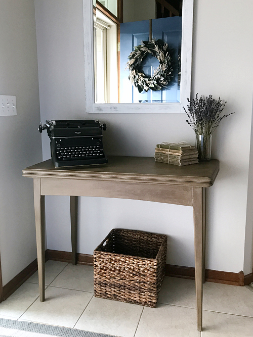 Table in an entry after given a weathered wood makeover using chalk paint and dark wax