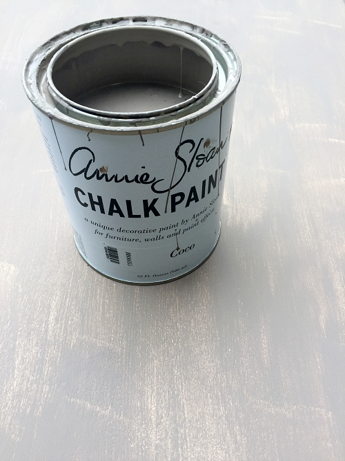 Annie Sloan chalk paint being used to create a weathered wood look on an entry table. First coat.