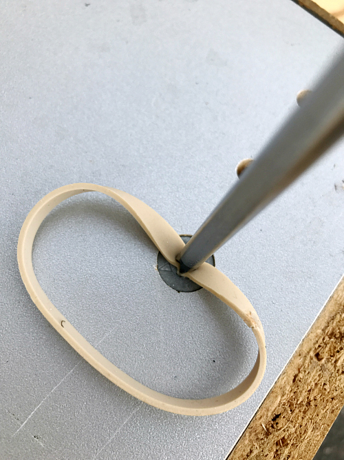 Using a rubber band to remove a stripped screw