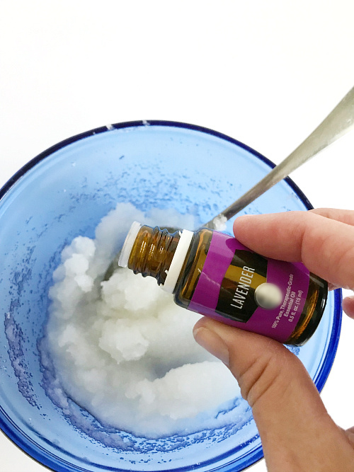 Adding lavender essential oil to lavender sugar scrub