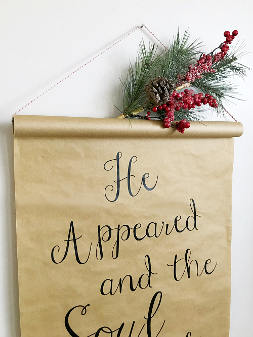 DIY Christmas scroll hung with greenery on top