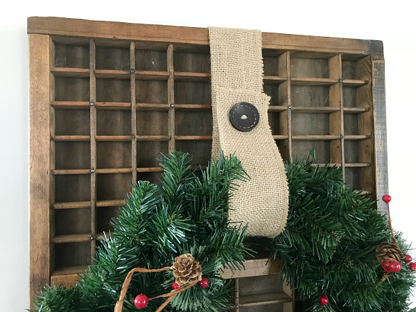 Letterboard with wreath hanging from burlap