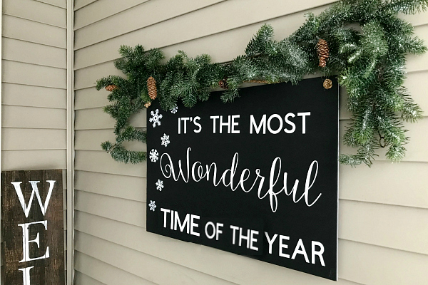 Such a cute Christmas porch. Love the budget-friendly signs that were added!