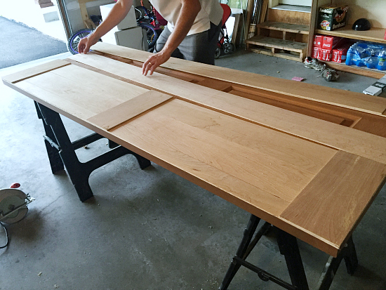 Placing strips of underlayment on a bifold door to create the look of a barn door