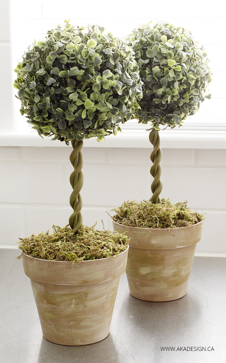 Budget friendly spring decor like these DIY topiary tress made with items from the dollar store