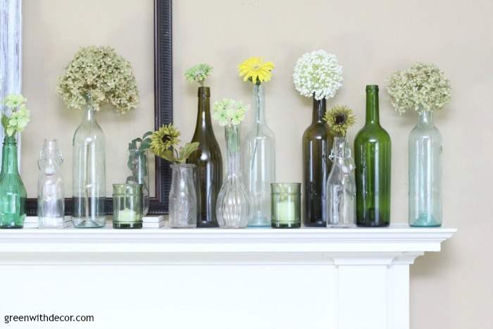 Vases in various colors and shapes are used for spring mantel