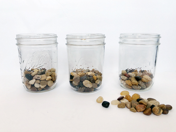 Pebbles added to mason jars to create drainage for the DIY Mason Jar Planter