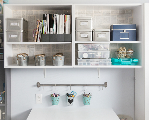 Book pages used to create a backsplash on a white shelving unit