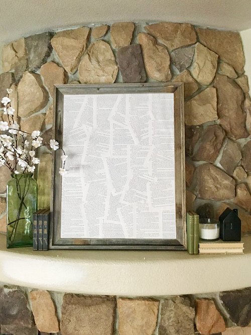 Framed book pages used to decorate a fireplace mantel