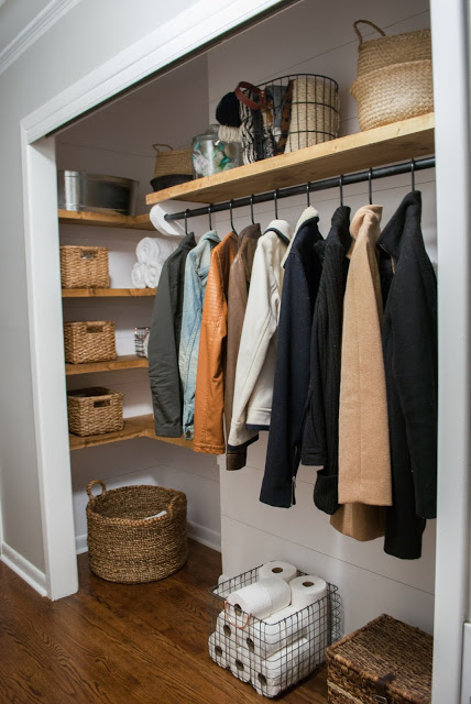 Coat closet after $100 makeover. Organized with wicker baskets.