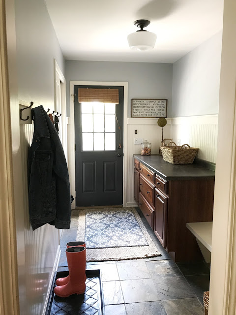 Mudroom after $100 makeover with freshly painted walls and door