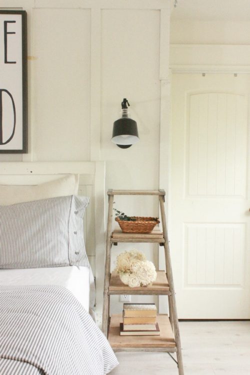 Wooden step ladder being used as a nightstand