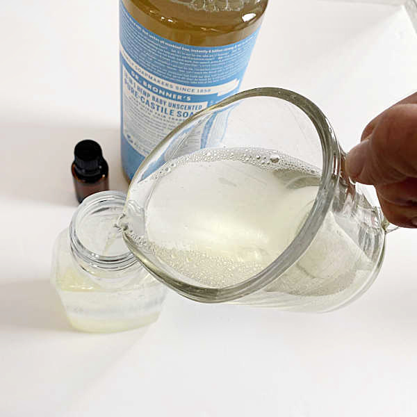 Pouring DIY Foaming Hand Soap into the dispenser