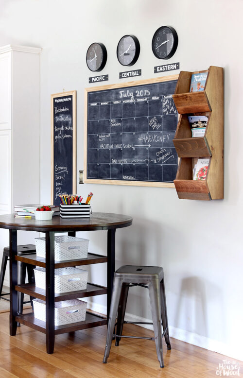 This command center was created by The House of Wood and features a large chalkboard calendar with clocks displaying the time in various time zones. It also has a three-tiered wooden bin to allow for books and magazines to be displayed.