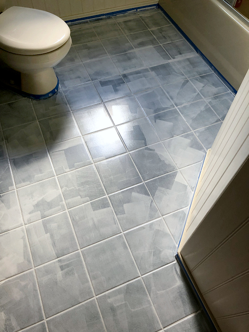 First coat of primer on tile floor in preparation for painting and stenciling