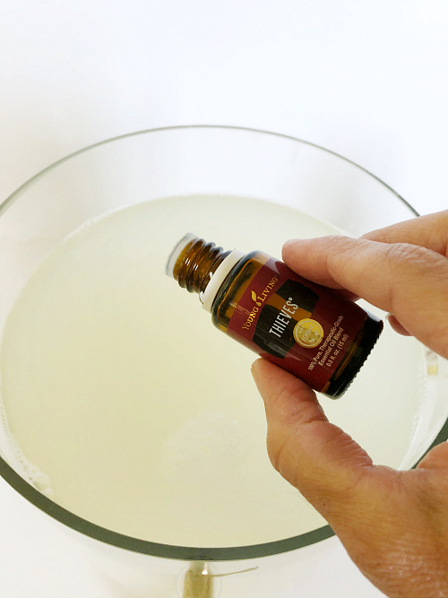 Adding Thieves essential oil to a DIY Thieves Laundry Detergent recipe