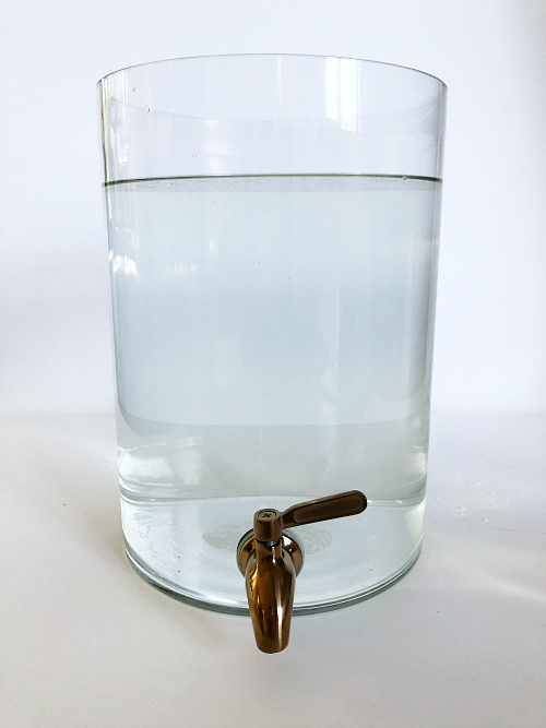 Drink dispenser filled with water and previously added ingredients which will make DIY Thieves Laundry Detergent