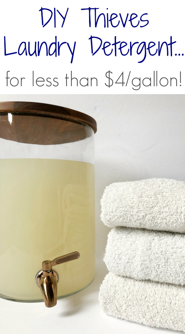 Pinterest Image showing DIY Thieves Laundry Detergent in a glass drink dispenser. White folded towels to the right. This DIY Laundry Detergent is free of harsh chemicals and costs less than $4/gallon. It's easy to make and smells amazing! #laundrysoap #laundrydetergent #thieves #essentialoils