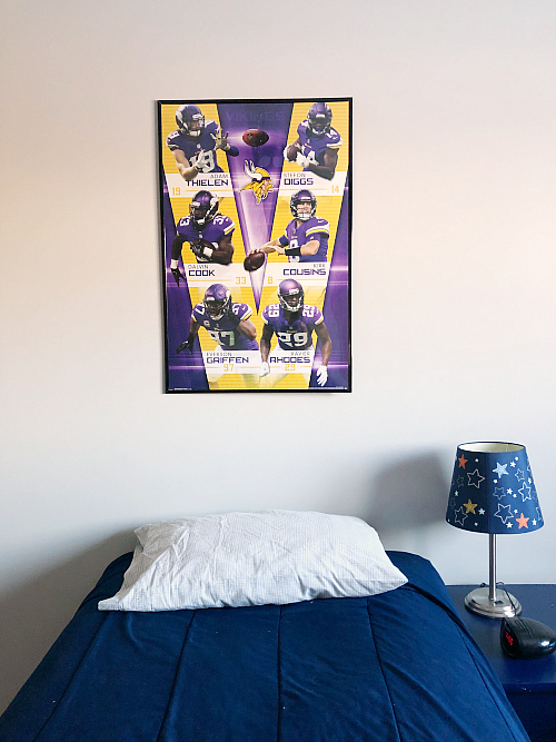 Framed poster above bed