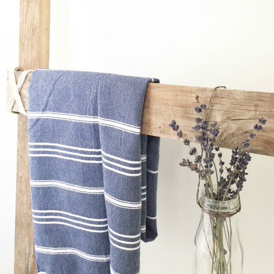 Blue striped Turkish towel hung from a wood ladder